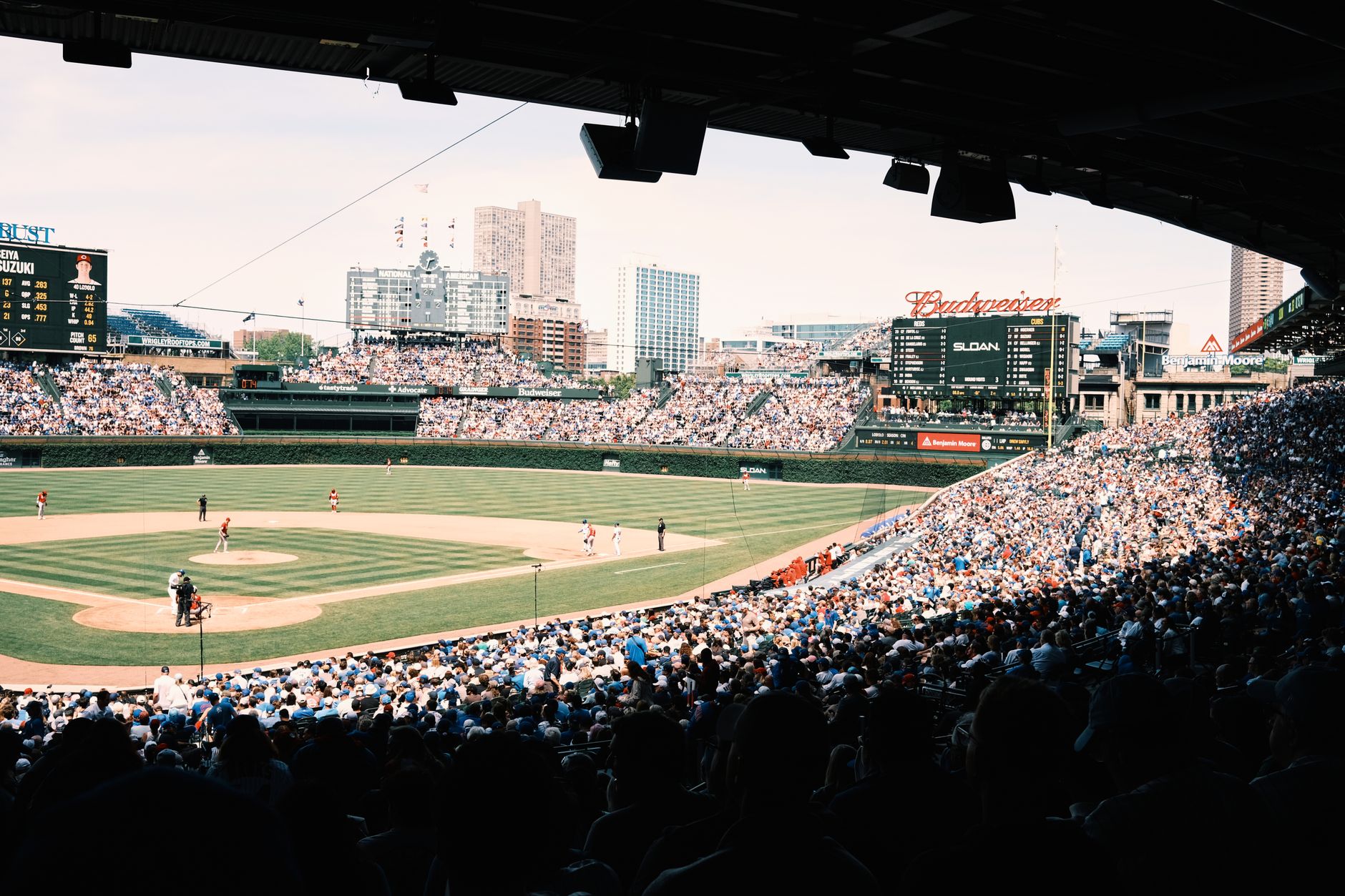 A lively baseball game at Wrigley Field with a packed crowd in Chicago, Illinois.